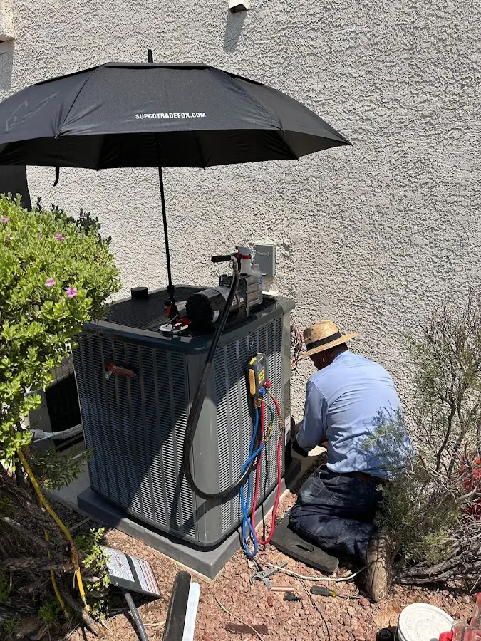 HVAC technician performing outdoor AC maintenance in Sleepy Hollow